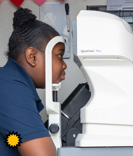 Girl resting head on eye exam device