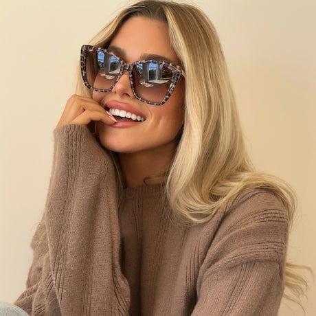 lifestyle - shelby hunstad wearing becky ii leopard print cat eye sunglasses with dusty pink knit sweater