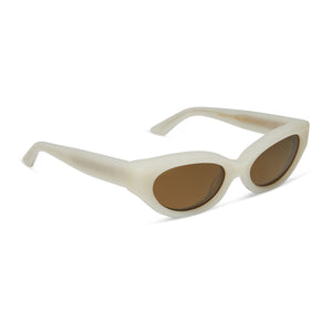 iconica diff eyewear petra cat eye sunglasses with a meringue cream colored acetate frame and brown polarized lenses angled view