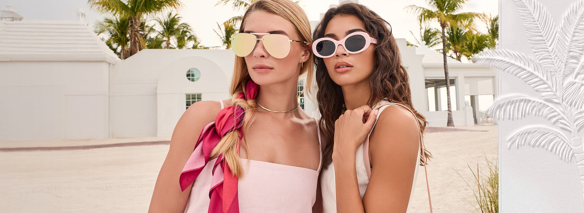 Brunette and blonde model wearing pink pastel outfits and mirrored aviator sunglasses and pastel pink sunglasses