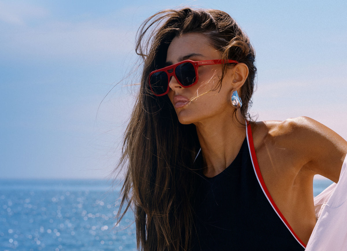 female on a boat wearing reserve sunglasses a collaboration between Beach Riot and DIFF Eyewaer