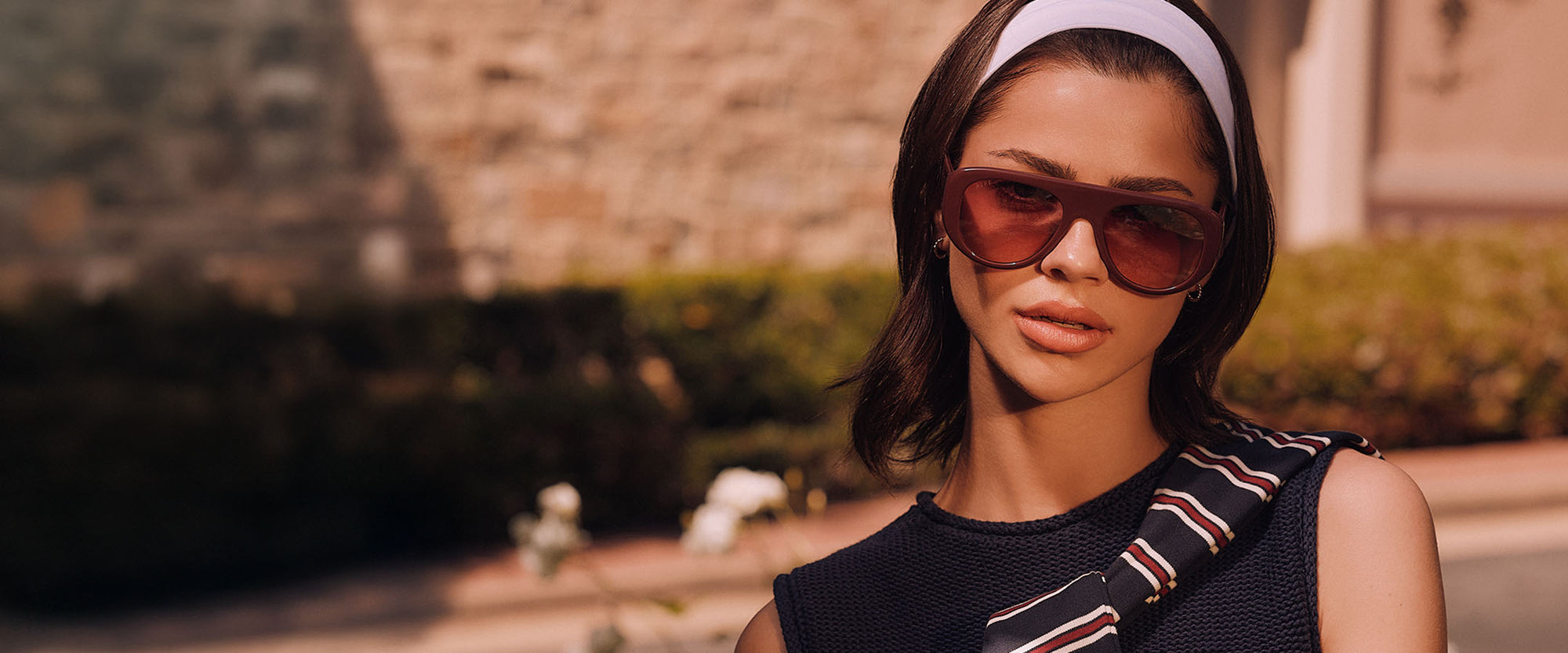 Video of blonde at country club with prep fashion and oversized square ivory sunglasses