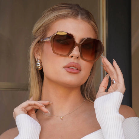 Blonde female wearing light brown oversized sunglasses