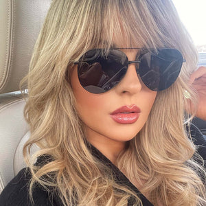 lifestyle - musicmellie wearing diff eyewear dash aviator sunglasses with matte black frame and solid grey polarized lens front view