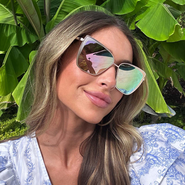 customer content - female wearing diff eyewear grace cat eye sunglasses with a brushed gold frame and cherry blossom mirror lenses