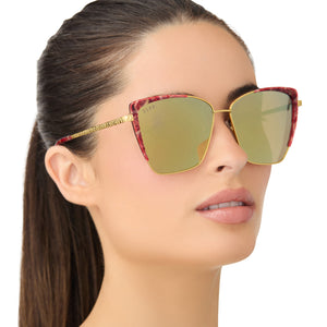 on model - female wearing star wars x diff eyewear queen amidala oversized cat eye sunglasses with a marbled naboo royal red with hammered gold frame and gold mirror polarized lenses angled view