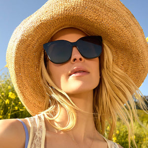 on model - female wearing Gia Black and Grey Oversized Cat Eye Sunglasses with large hat