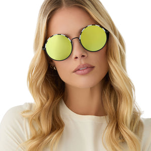 on model - female wearing beetlejuice x diff eyewear featuring the beetlejuice round sunglasses with a black frame and lime green mirror lenses front view