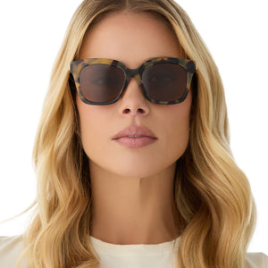 on model - female wearing diff eyewear featuring the bella xs square sunglasses with a brown kombu frame and brown polarized lenses front view