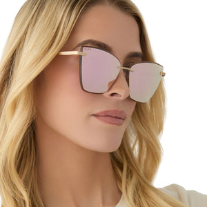on model - female wearing diff eyewear featuring the becky v cat eye sunglasses with a brushed gold frame and cherry blossom mirror lenses side view
