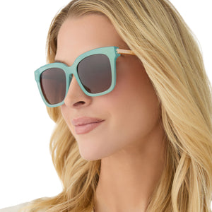 on model - female wearing diff eyewear featuring the bella square sunglasses with a aquatic awe frame and brown gradient polarized lenses angled view