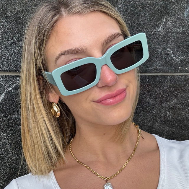 customer content - female wearing diff eyewear featuring the indy rectangle sunglasses with a steel teal frame and grey polarized lenses front view