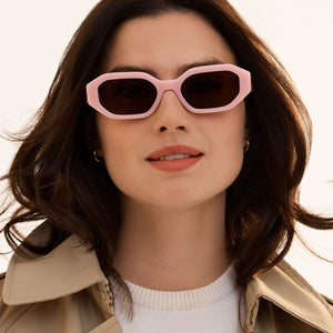 on model - brunette female wearing diff eyewear featuring the allegra rectangle sunglasses with a pink velvet frame and grey polarized lenses front view