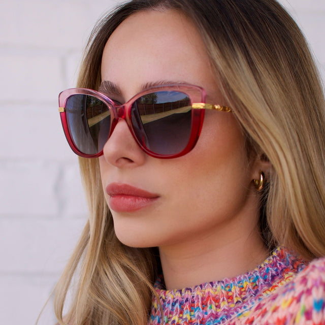 customer content - larissa.montana wearing harry potter x diff eyewear featuring the hermione 2.0 cateye sunglasses with a ombré pink frame and blue bell gradient lenses front view
