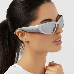 on model - female wearing diff sport side out wrap sunglasses with a silver frame and silver mirror polarized lenses side view