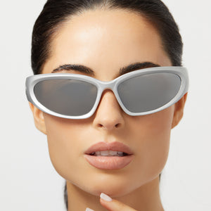 on model - female wearing diff sport side out wrap sunglasses with a silver frame and silver mirror polarized lenses front view