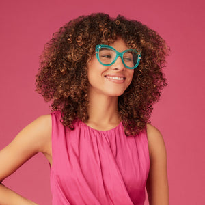on model - female wearing disney princess x diff eyewear featuring the princess jasmine cat eye prescription glasses with a teal frame full view