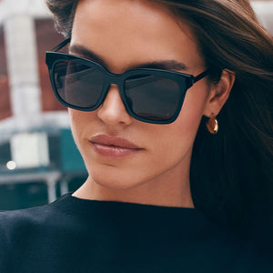 on model - female wearing diff eyewear bella black frame grey polarized lenses sunglasses front view