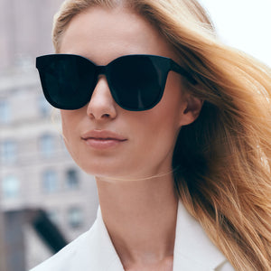 on model - female wearing diff eyewear gia square oversized sunglasses with a black frame and grey lenses front view