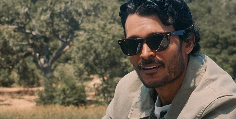 Male model in studio wearing black square sunglasses