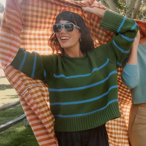 lifestyle - female wearing diff eyewear cameron navigator sunglasses with a dew drop blue acetate frame and brown gradient polarized lenses front view