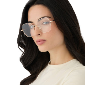 on model - female wearing diff eyewear featuring the harlowe hexagon prescription glasses with a gold frame angled view