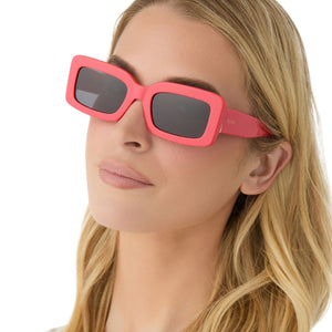 on model - female wearing diff eyewear featuring the indy rectangle sunglasses with a sunset bright coral frame and grey lenses angled view