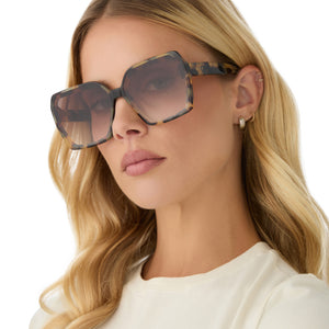 on model - female wearing diff eyewear featuring the presley square sunglasses with a brown kombu frame and brown gradient lenses angled view