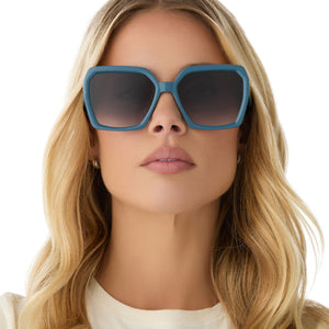 on model - female wearing diff eyewear featuring the sloane square sunglasses with a deep space blue frame and grey gradient lenses front view