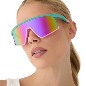 on model - female wearing diff sport featuring the spike shield sunglasses with a turquoise & hot pink frame and pink rush mirror polarized lenses front view