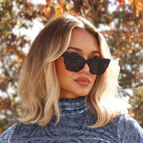 minimally her wearing alina cat eye tort frames with fall leaves and fashion