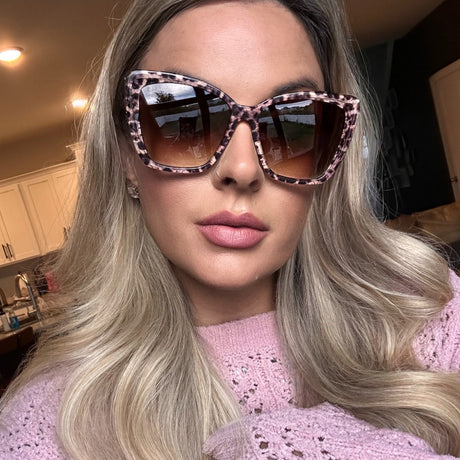 lifestyle - music mellie wearing becky ii leopard print cat eye sunglasses with dusty pink knit sweater