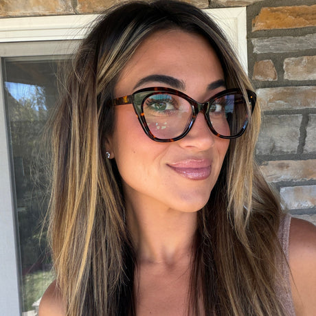 lifestyle - ashley smith blonde influencer wearing gold wire frame eyeglasses with striped button up shirt