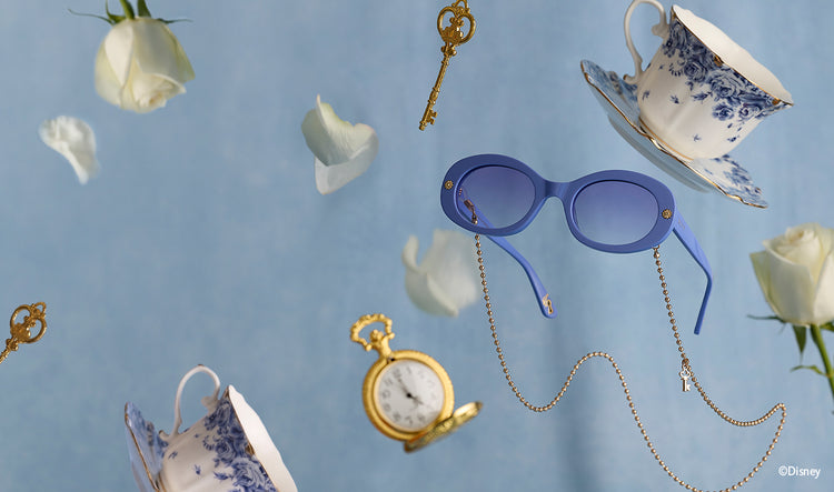 Blue Alice in Wonderland sunglasses floating among pocket watch and teacup