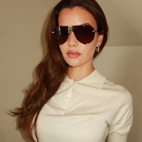 lifestyle - stephanie brightt wearing lonnie shield brown gradient sunglasses with cream colored polo