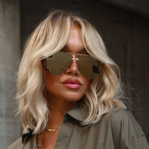 lifestyle - minimally her blonde influencer wearing gold aviator sunglasses with gold necklace