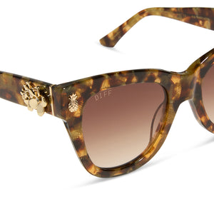 the white lotus x diff eyewear featuring the hawaii cat eye sunglasses with a coconut palm tortoise frame and brown gradient lenses detailed view