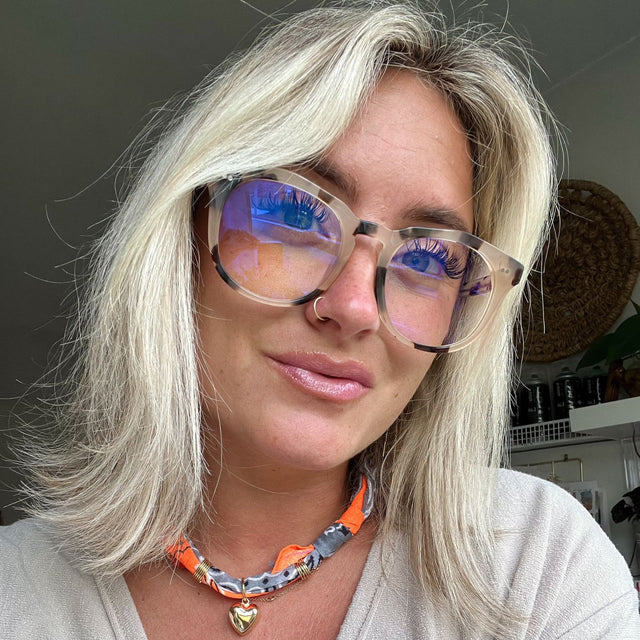customer content - blonde female wearing cream tort blue light glasses