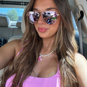 lifestyle - jordan reece wearing pink aviators with pink tank top in car