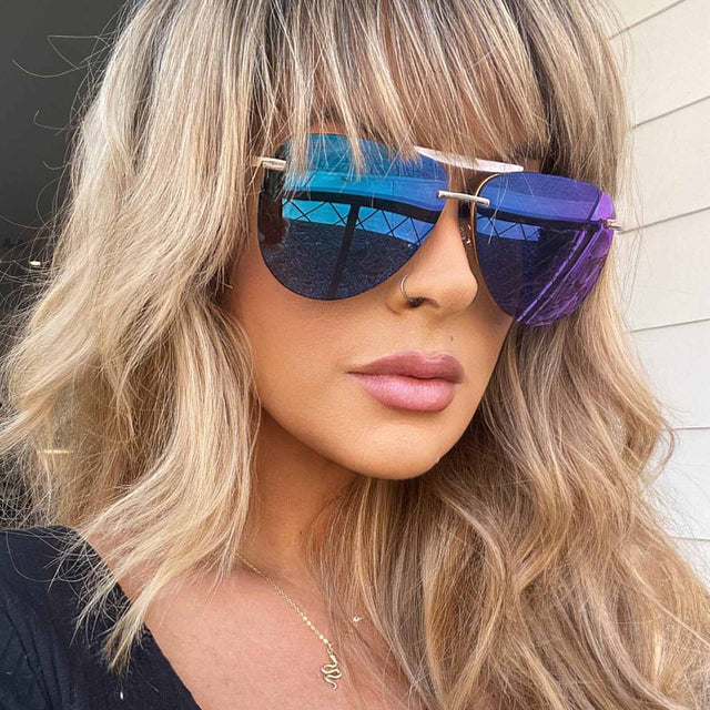 customer content - female wearing diff eyewear tahoe aviator sunglasses with a gold frame and purple mirror lenses
