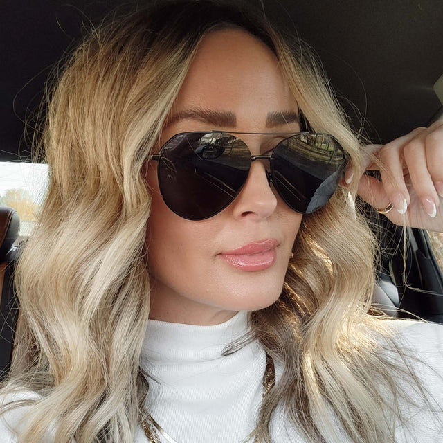 customer content - blonde female wearing dash aviator sunglasses with a matte black metal frame and solid grey polarized lenses