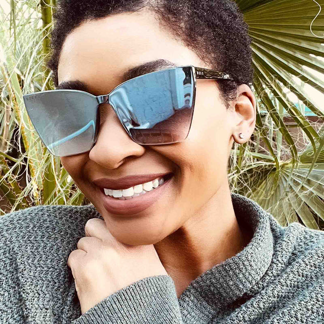 customer content - female outdoors wearing diff eyewear goldie cat eye sunglasses with a black frame and grey smoke flash lenses