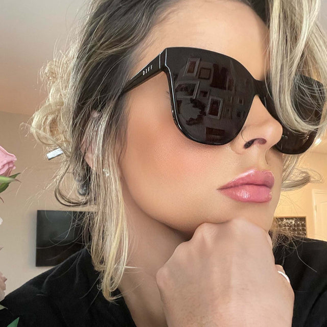 customer content - female wearing diff eyewear gia round sunglasses with a black frame and grey lenses