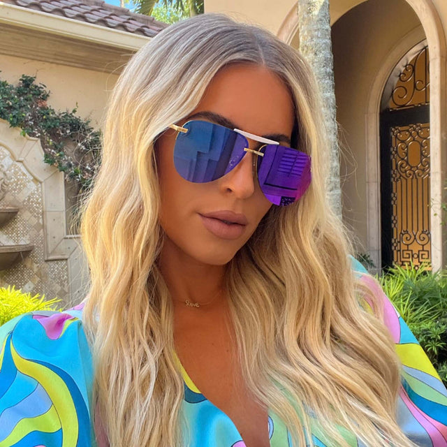 customer content - female wearing diff eyewear tahoe aviator sunglasses with a gold frame and purple mirror lenses