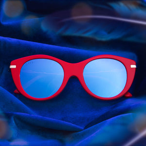 lifestyle - harry potter x diff eyewear flat lay of luna lovegood sunglasses on a blue cloth