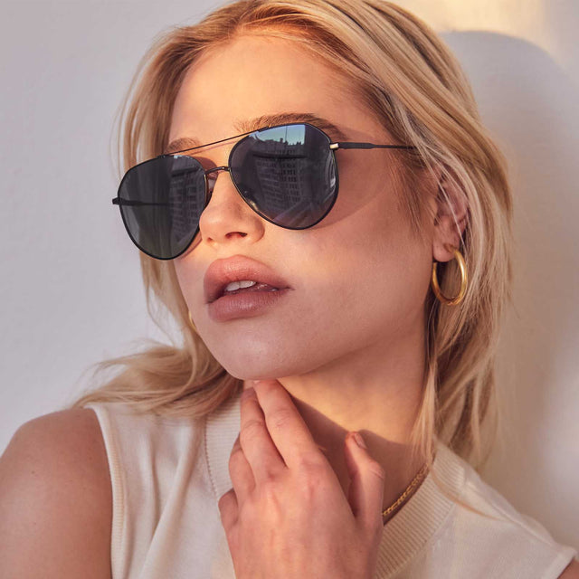 customer content - blonde woman wearing dash - matte black and solid grey womans polarized aviator sunglasses